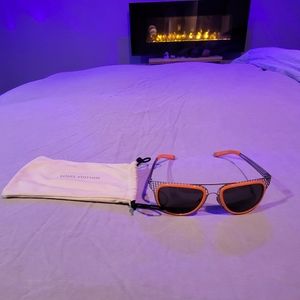 Louis Vuitton orange cage sunglasses.